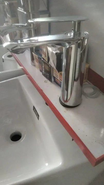 A chrome basin mixer and wash basin tap installed on a bathroom sink, showing how it fits into your bathroom accessories