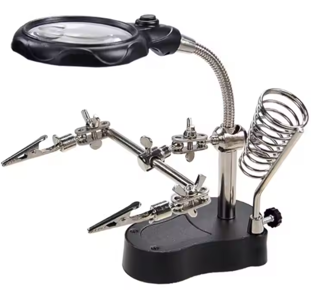 Soldering station with magnifying glass and tools on a white background